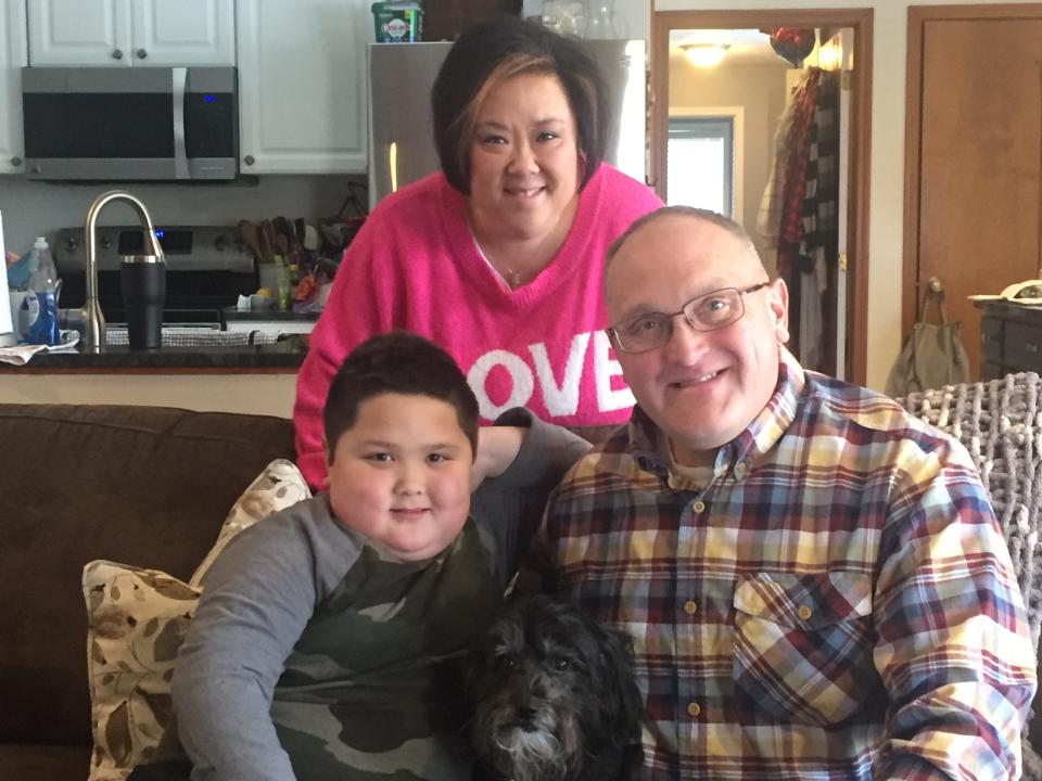 George Davis poses for a family portrait with son Park and wife Stacy (and dog Valentino) after returning from a 10-month deployment.