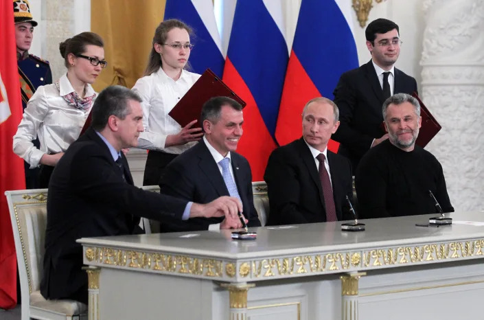 Front row, left to right: Crimean Prime Minister Sergei Aksyonov, Chairman of the Crimea State Council Vladimir Konstantinov, Russian President Vladimir Putin and Mayor of Sevastopol Alexei Chaly at the Grand Kremlin Palace in Moscow