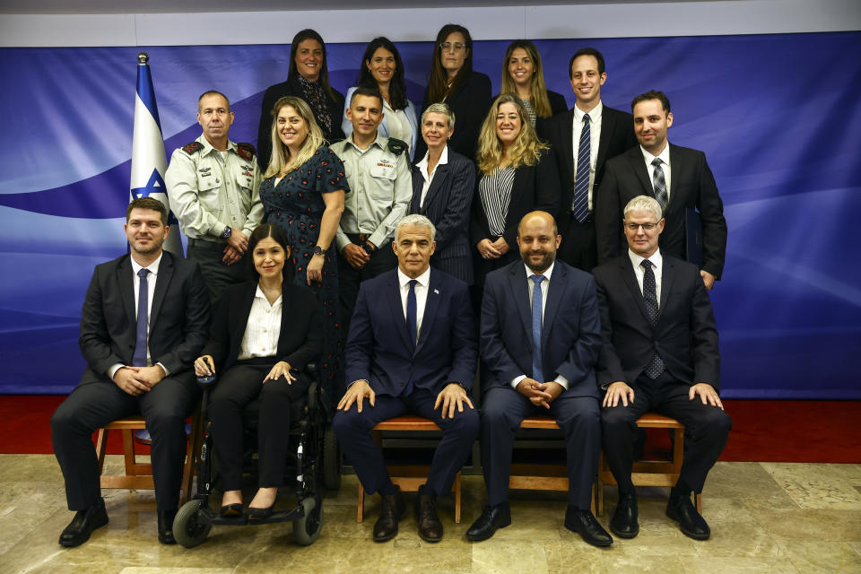 Israeli Prime Minister Yair Lapid, center front, is photographed with the Israeli negotiation team after the U.S.-brokered deal setting a maritime border between Israel and Lebanon, at the Prime Minister's office in Jerusalem, Thursday, Oct. 27, 2022. Lebanon signed and delivered its copy of a U.S.-mediated sea border deal with Israel on Thursday to a U.S. mediator, hoping to soon start exploring gas in its southern maritime blocs to bring economic stability to the crisis-ridden country. (Ronen Zvulun/Pool Photo via AP)