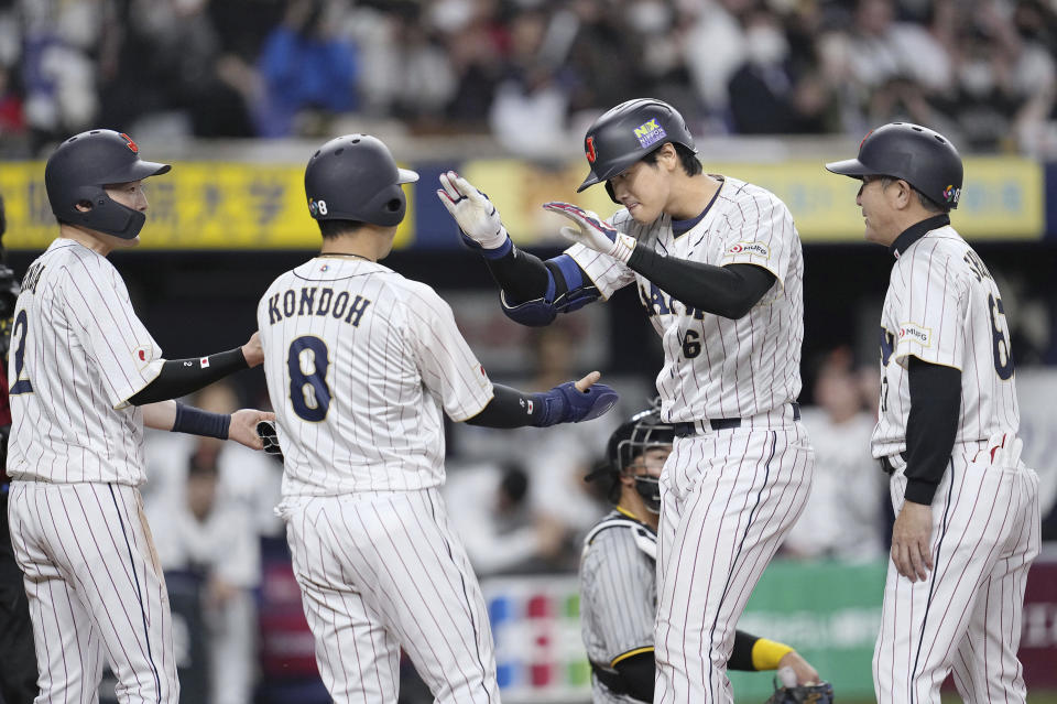 Shohei Ohtani de Japón celebra con sus compañeros su jonrón de trs carreras en la quinta entrada del duelo de exhibición ante Hanshin Tigers en Osaka antes del Clásico Mundial de Béisbol el lunes 6 de marzo del 2023. (Kyodo News via AP)