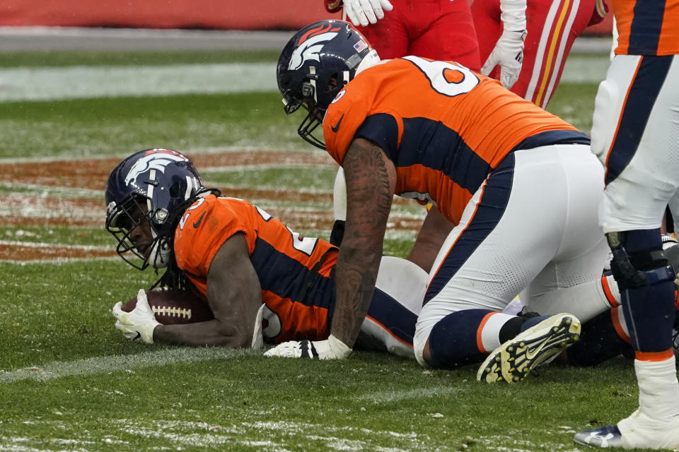 Denver Broncos running back Melvin Gordon, left, scores a touchdown during the second half of an NFL football game against the Kansas City Chiefs, Sunday, Oct. 25, 2020, in Denver. (AP Photo/Jack Dempsey)