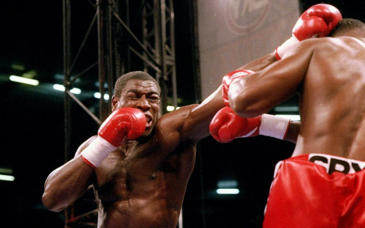 ennox Lewis trades blows with Frank Bruno during a fight in Cardiff, Wales.