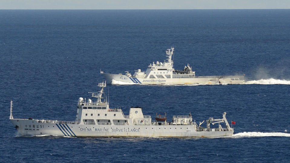 The Chinese surveillance ship Haijian No. 51, front, sails ahead of a Japan Coast Guard vessel in waters near disputed islands, called Senkaku in Japan and Diaoyu in China, in the East China Sea on Friday morning, Sept. 14, 2012. The Japanese government and coast guard say six Chinese surveillance ships entered Japanese waters Friday near disputed islands in the East China Sea, prompting the prime minister’s office to mobilize a task force at its crisis management center. (AP Photo/Kyodo News) JAPAN OUT, MANDATORY CREDIT, NO LICENSING IN CHINA, HONG KONG, JAPAN, SOUTH KOREA AND FRANCE