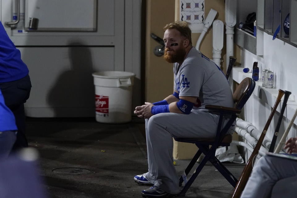 Los Angeles Dodgers' Justin Turner looks on from the dugout during the second inning in Game 4 of a baseball NL Division Series against the San Diego Padres, Saturday, Oct. 15, 2022, in San Diego. (AP Photo/Jae C. Hong)