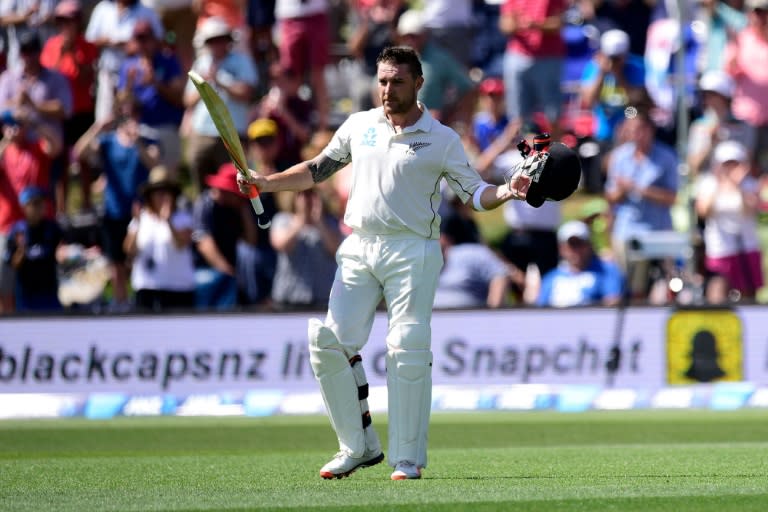 Brendon McCullum, captain of New Zealand, lifts his bat and helmet to the fans as he walks from the field for the last time during day one of the second cricket Test match between New Zealand and Australia in Christchurch on February 20, 2016