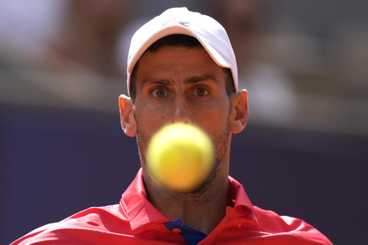 Serbia's Novak Djokovic eyes the ball as he plays against Spain's Carlos Alcaraz during the men's singles tennis final at the Summer Olympics on Sunday.