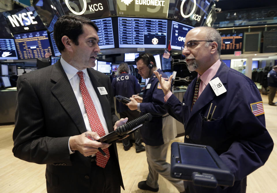 Traders Mark Muller, left, and John Liotti, right, work on the floor of the New York Stock Exchange, Monday, April 7, 2014. Stocks are starting out the week the same way they ended the last one, down. (AP Photo/Richard Drew)