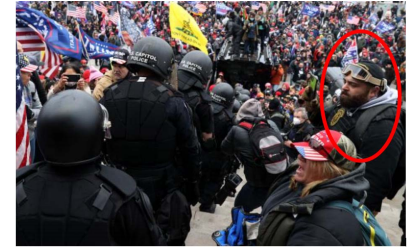 Roberto Minuta uses a cellphone to video U.S. Capitol officers during Jan. 6, 2021, riot in Washington, D.C.