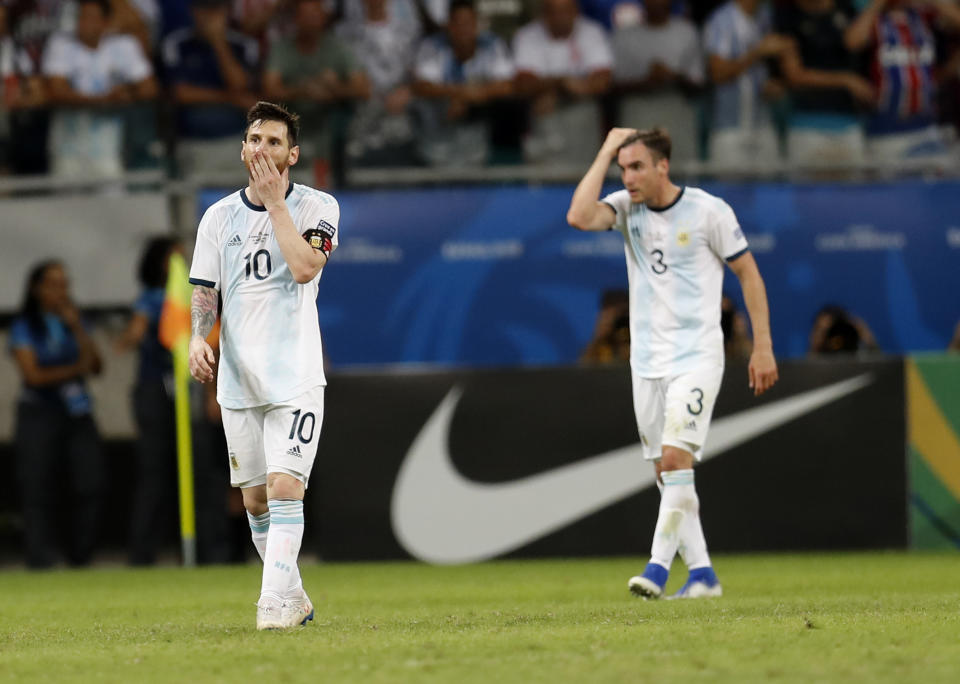 Argentina's Lionel Messi, left, and Argentina's Nicolas Tagliafico walk out of the pitch at the end of the Copa America Group B soccer match against Colombia at the Arena Fonte Nova in Salvador, Brazil, Saturday, June 15, 2019. Colombia won 2-0. (AP Photo/Natacha Pisarenko)