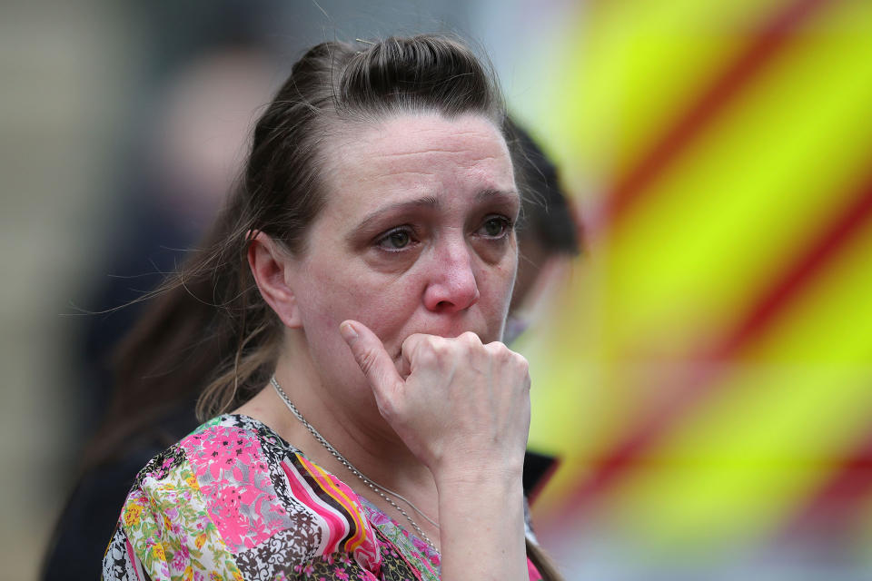 <p>A woman looks upset after police evacuated the Arndale Center on May 23, 2017 in Manchester, England. (Photo: Christopher Furlong/Getty Images) </p>