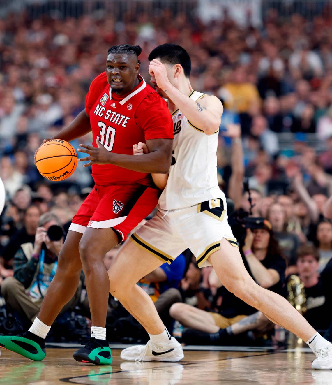 NC State’s DJ Burns tries to muscle to the basket against Purdue’s Zach Edey during the first half of their NCAA Final Four game. Ethan Hyman/ehyman@newsobserver.com