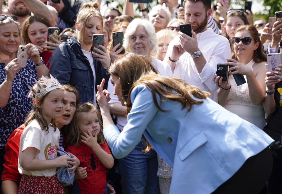 Kate the Princess of Wales speaks to members of the public, during a walkabout on the Long Walk near Windsor Castle where the Coronation Concert to celebrate the coronation of King Charles III and Queen Camilla is being held, in Windsor, England, Sunday May 7, 2023. (Andrew Matthews/Pool Photo via AP)