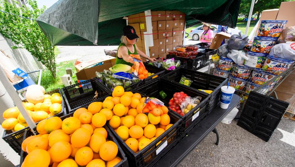 Bridget Dolan organizes fruit as she works at Pantry 279 distributing food on Wednesday, June 15, 2022.