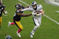 Philadelphia Eagles quarterback Carson Wentz (11) scrambles out of the pocket under pressure by Philadelphia Eagles defensive tackle Hassan Ridgeway (98) during the second half of an NFL football game, Sunday, Oct. 11, 2020, in Pittsburgh. (AP Photo/Keith Srakocic)