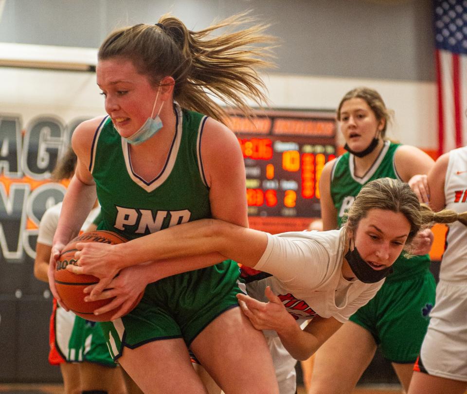 Winnebago's Campbell Shrank, right, tries to strip the ball from Peoria Notre Dame's Kaitlin Cassidy during the first quarter of their game on Saturday, Jan. 15, 2022, in Winnebago.