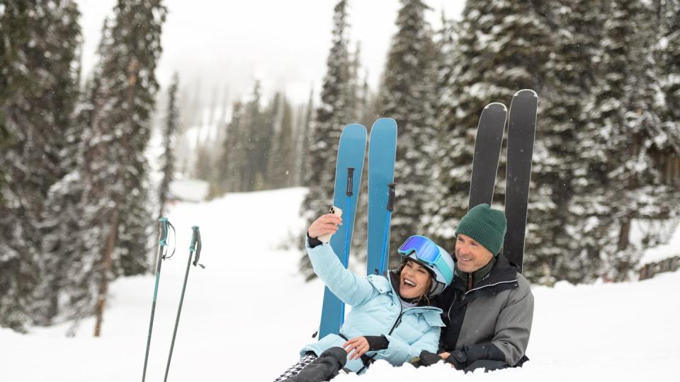 woman and man taking a selfie while skiing
