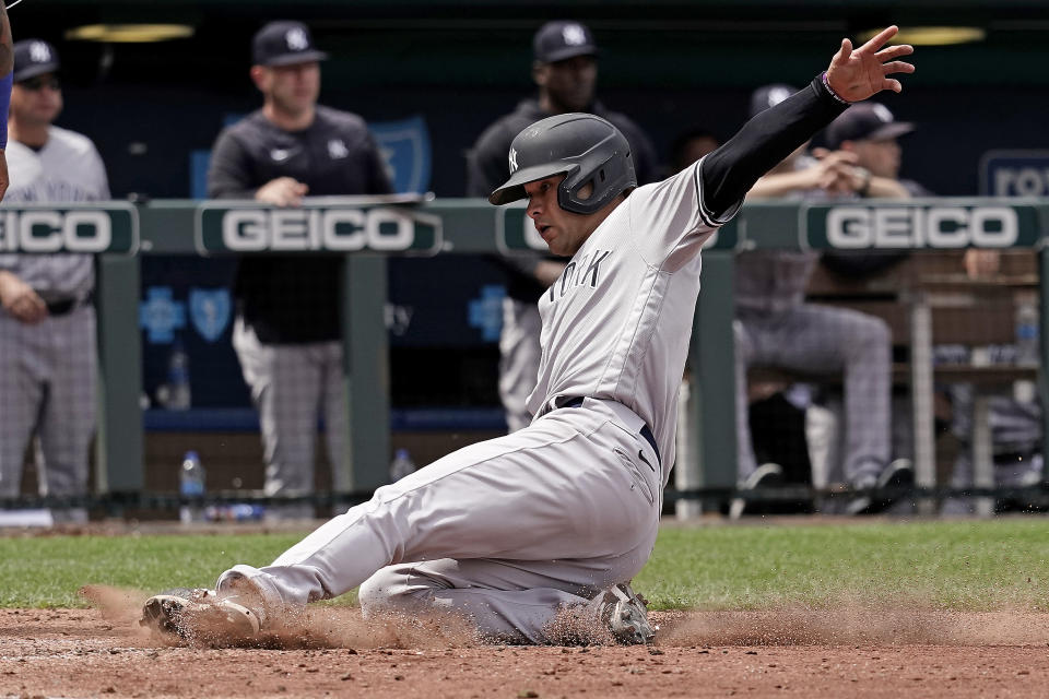 New York Yankees' Isiah Kiner-Falefa slides home to score on a single by DJ LeMahieu during the fifth inning of a baseball game against the Kansas City Royals Sunday, May 1, 2022, in Kansas City, Mo. (AP Photo/Charlie Riedel)