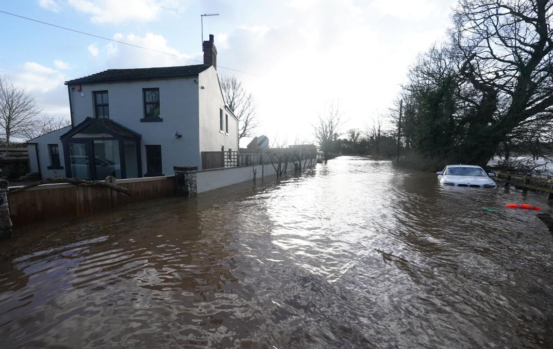 A car stranded in flood water in Warwick bridge in Cumbria. Thousands of people have been left without power as Storm Isha brought disruption to the electricity and transport networks across the UK. Picture date: Monday January 22, 2024.