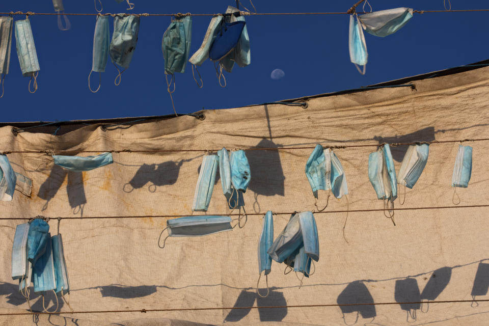 Face masks hang on a boat during a nationwide lockdown to curb the spread of the coronavirus, at the port in the mixed Arab Jewish city of Jaffa, near Tel Aviv, Israel, Wednesday, Oct. 7, 2020. (AP Photo/Oded Balilty)