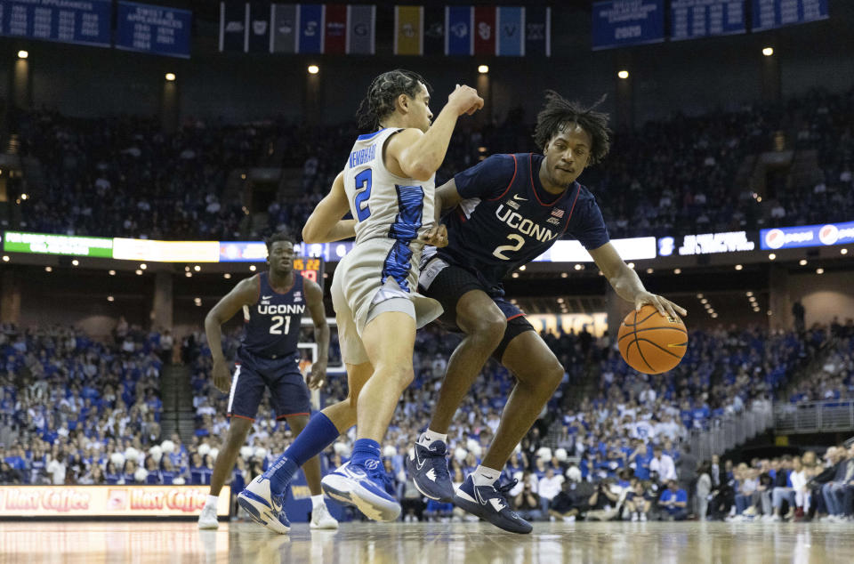 UConn's Tristen Newton, right, drives against Creighton's Ryan Nembhard during the first half of an NCAA college basketball game on Saturday, Feb. 11, 2023, in Omaha, Neb. (AP Photo/Rebecca S. Gratz)