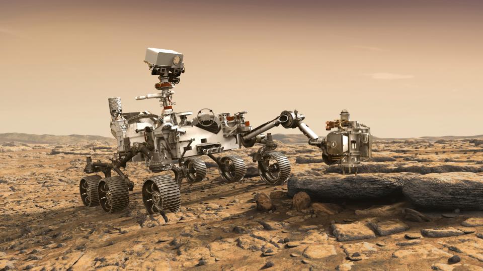 In this illustration made available by NASA, the Mars 2020 Perseverance rover studies a Mars rock outrcrop. The Perseverance Mars rover is due to land on Mars  Feb. 18, 2021. A key objective for Perseverance's mission on Mars is astrobiology, including the search for signs of ancient microbial life. The rover will characterize the planet's geology and past climate, paving the way for human exploration of the Red Planet, and be the first mission to collect and cache Martian rock and regolith.