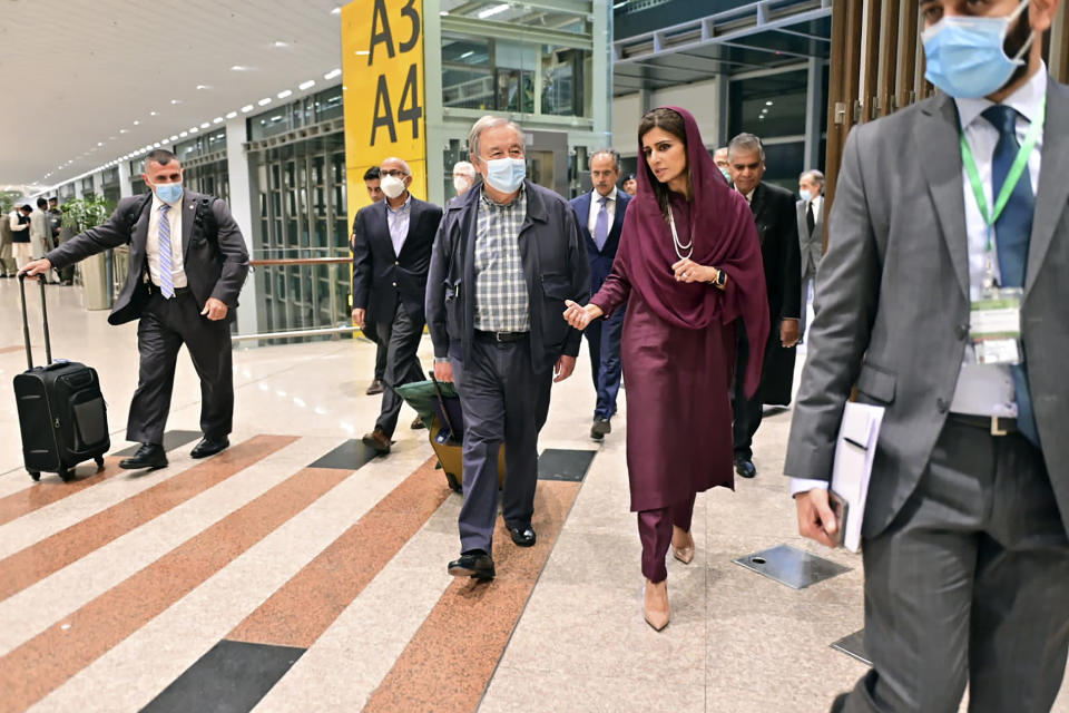 In this handout photo released by Pakistan Foreign Ministry Press Service, U.N. Secretary-General Antonio Guterres, center, was received on his arrival by Deputy Foreign Minister Hina Rabbani Khar, second right, in Islamabad, Pakistan, Friday, Sept. 9, 2022. U.N. Guterres appealed to the world to help Pakistan after arriving in the country Friday to see damage from the record floods that have killed hundreds and left more than half a million people homeless and living in tents under the open sky. (Pakistan Foreign Ministry Press Service via AP)