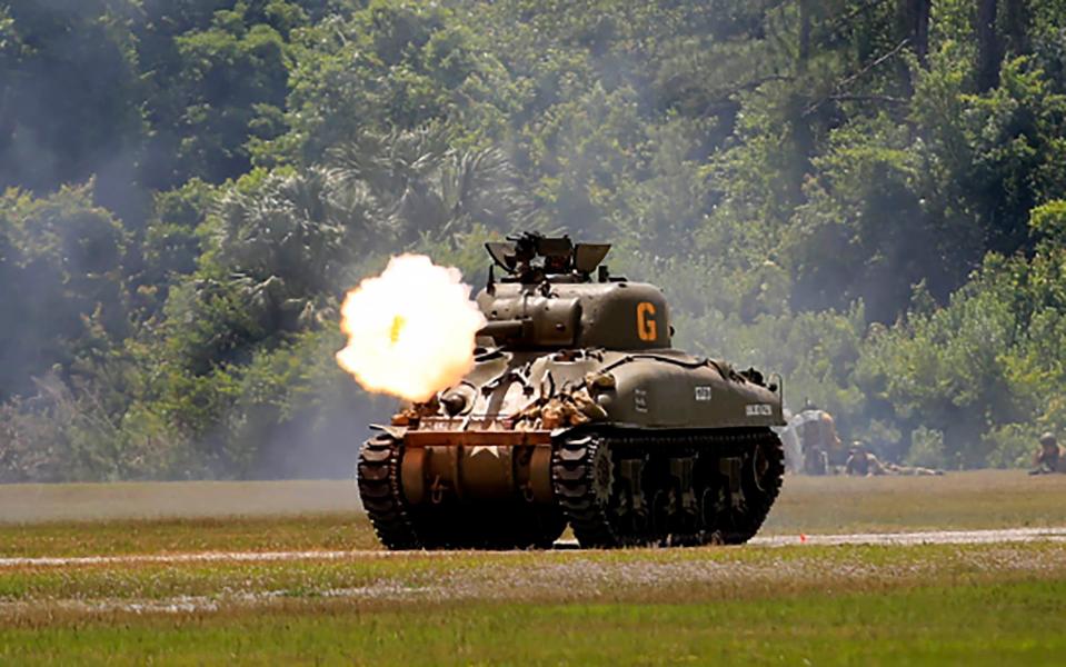 An M4 tank fires across the field during a WW II re-enactment at the Volusia County fairgrounds on Saturday, May 4th, 2024. The tank was not using live ammo in the re-enactment.