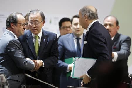 French President Francois Hollande (L) shakes hands with United Nations Secretary-General Ban Ki-moon (C) near Foreign Affairs Minister Laurent Fabius (C), President-designate of COP21, at the World Climate Change Conference 2015 (COP21) at Le Bourget, near Paris, France, December 12, 2015. REUTERS/Stephane Mahe