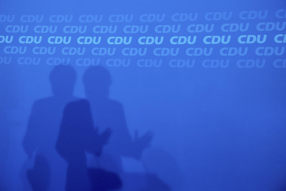 The shadow is seen of German Christian Democratic Party, CDU, chairwoman and Chancellor Angela Merkel, during a news conference after a party's leaders meeting at the headquarters the in Berlin, Germany, Monday, Oct. 29, 2018. {Kay Nietfeld/dpa via AP)