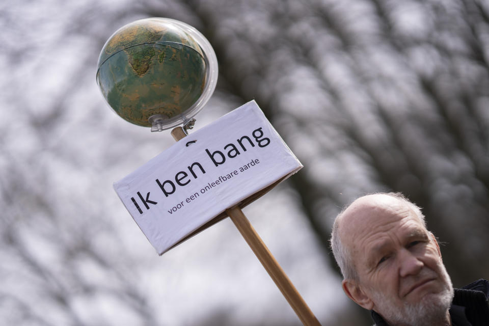 A protestor holds a sign reading "I'm Afraid of an Unlivable Planet" as protestors gathered to block a highway during a climate protest by Extinction Rebellion and other activists near the Dutch parliament, in The Hague, Netherlands, Saturday, April 6, 2024. (AP Photo/Peter Dejong)