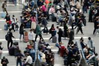 Passengers wait to board trains at Shanghai Hongqiao railway station ahead of the five-day Labour Day holiday, in Shanghai