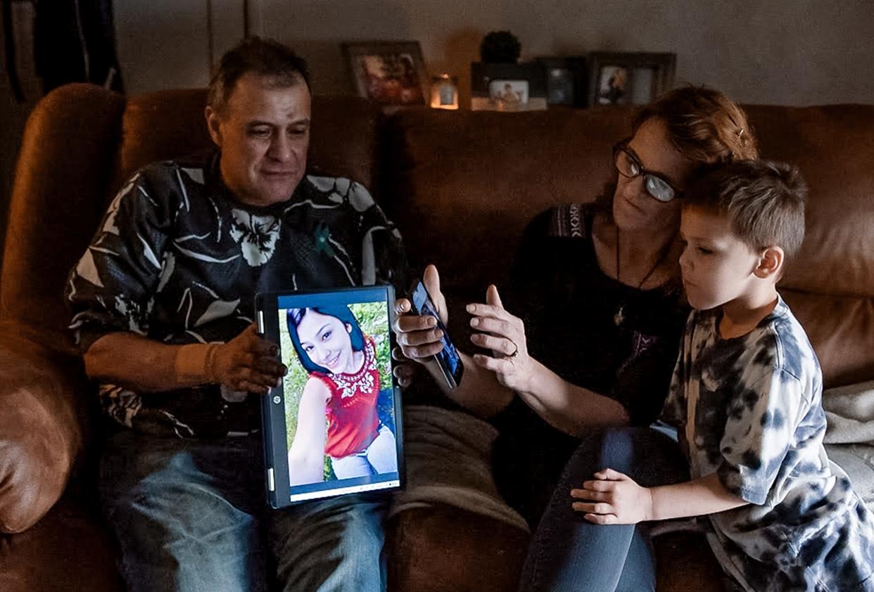 Freddy Corona and his wife, Shawna Normali, look at photos of their daughter, Lena Corona, with their son, Josh Corona. Lena Corona was in psychosis in July when she was arrested and taken to the Seminole County jail where she died by suicide.