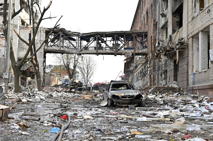 Rescuers sifting through the debris of buildings destroyed following the bombardment of Kharkiv, April 16, 2022