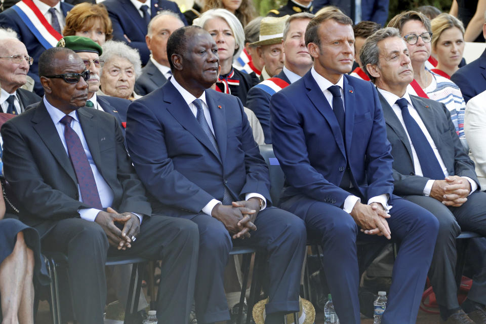 French President Emmanuel Macron, second right, former French President Nicolas Sarkozy, right, Ivory Coast's President Alassane Ouattara, second left, and Guinean President Alpha Conde attend a ceremony marking the 75th anniversary of the WWII Allied landings in Provence, in Saint-Raphael, southern France, Thursday, Aug. 15, 2019. Starting on Aug. 15, 1944, French and American troops — 350,000 in total — landed on the French Riviera. U.S. forces drove north while French troops — many from French colonies in Africa — moved along the coast to secure key ports. (Eric Gaillard/POOL via AP)