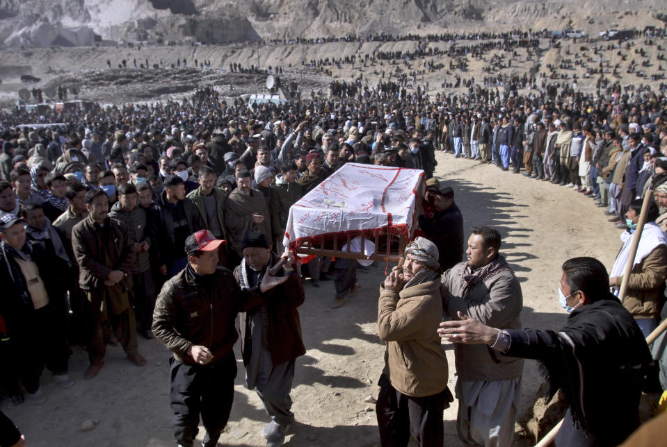 People carry the coffin of a coal mine worker, who along with others was killed by gunmen near the Machh coal field in Quetta, Pakistan, Saturday, Jan. 9, 2021. Hundreds of Pakistani Shiites gathered to bury 11 coal miners from the minority Hazara community who were killed by the Islamic State group, ending over a week of protests that sought to highlight the minority community's plight. (AP Photo/Arshad Butt)