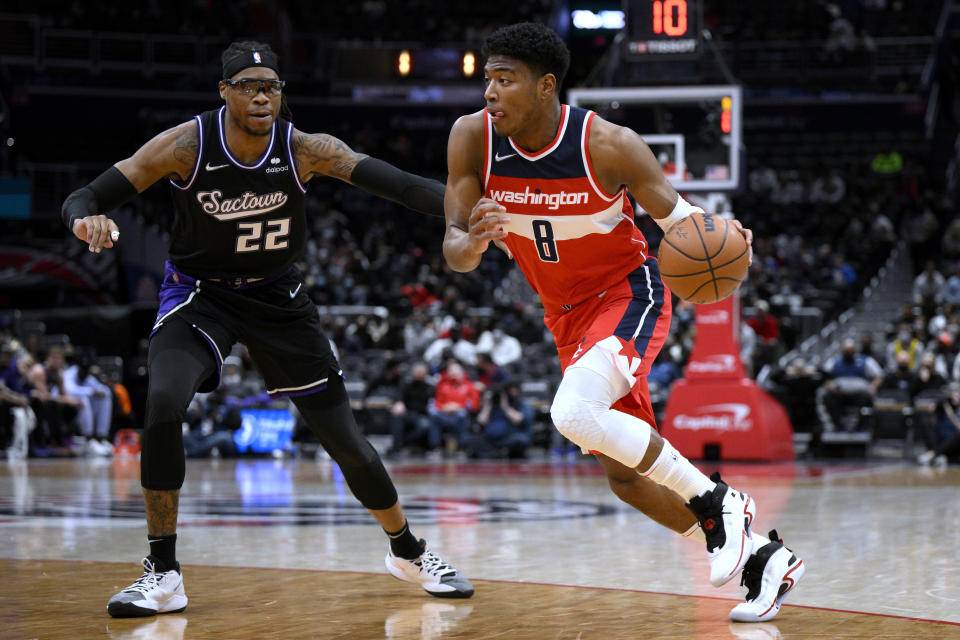 Washington Wizards forward Rui Hachimura (8) drives against Sacramento Kings center Richaun Holmes (22) during the first half of an NBA basketball game Saturday, Feb. 12, 2022, in Washington. (AP Photo/Nick Wass)