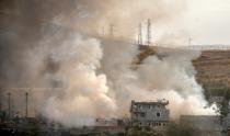 Smoke rises from damaged police headquarters after a suicide truck bombing killed eleven Turkish police officers and injured 78 people on August 26, 2016 in Cizre, southeastern Turkey, in an attack blamed on Kurdish militants, state media said