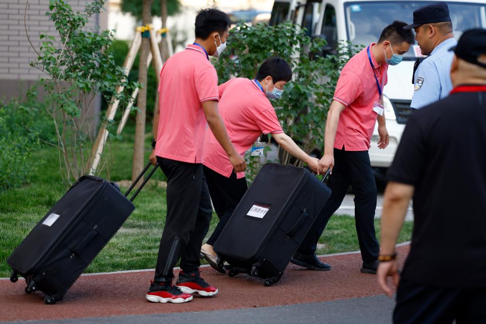 Staff members of the Haidian Educational Enrollment and Examination Center transfer a suitcase containing the test papers of Beijing 2023 college entrance exam on June 7, 2023 in Beijing, China. 2023 National College Entrance Exam (aka Gaokao) officially kicks off on June 7.