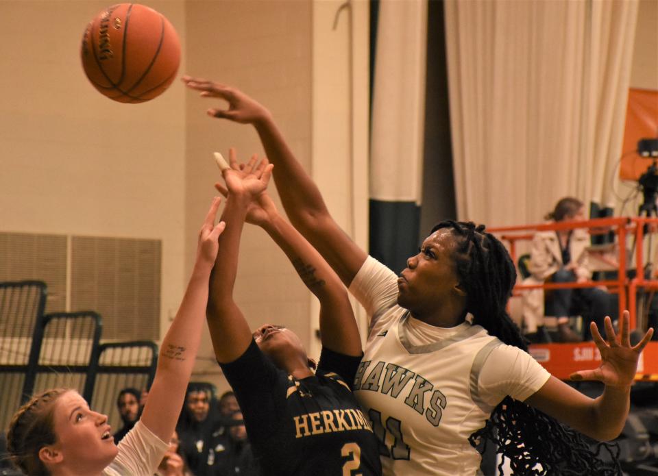 Mohawk Valley Community College's Terah Echols swats teh ball away from Herkimer College General Kapri Bradshaw (2)Tuesday, Nov. 29, 2022, in Herkimer, New York.