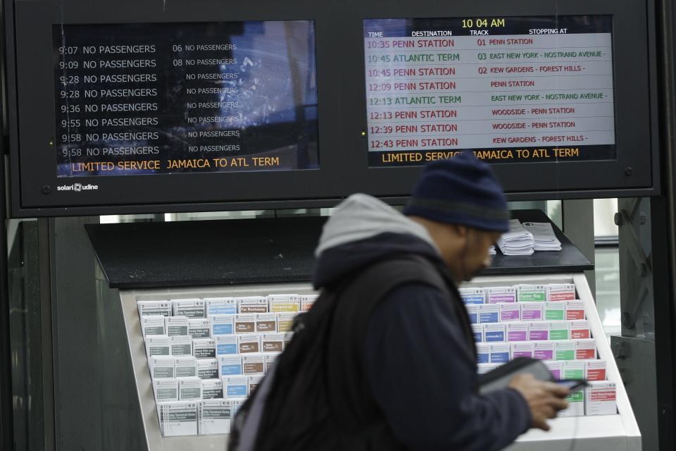 A commuter walks past monitors showing limited service at the Long Island Rail Road Jamaica Station Thursday, Nov. 1, 2012, in the New York City borough of Queens. Three days after superstorm Sandy made landfall, residents and commuters still faced obstacles as they tried to return to pre-storm routines. (AP Photo/Frank Franklin II)