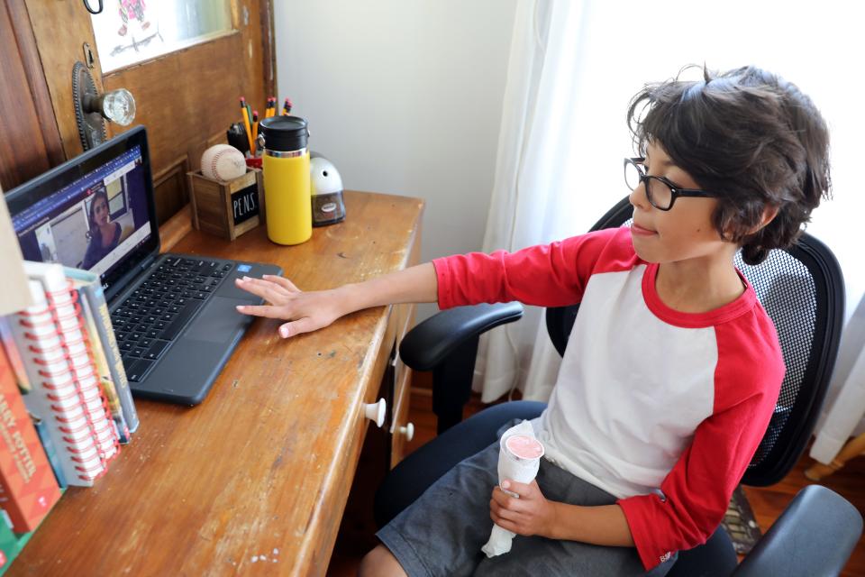 Fourth-grader Landon Chavez, 9, attends class remotely May 25 at home in Ossining, New York. Landon and his sister Zoey, 5, have been remote all year.