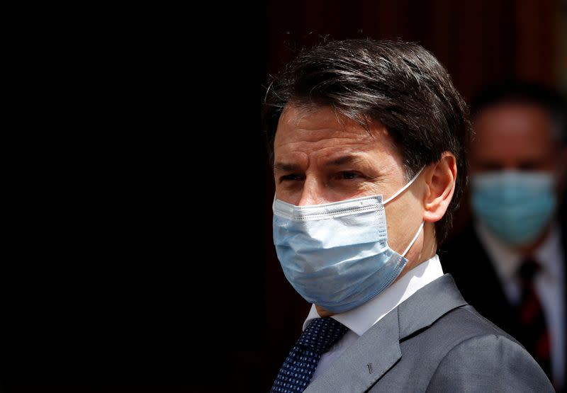 FILE PHOTO: Italian Prime Minister Giuseppe Conte wearing a protective face mask, leaves the Senate as the spread of the coronavirus disease (COVID-19) continues, in Rome