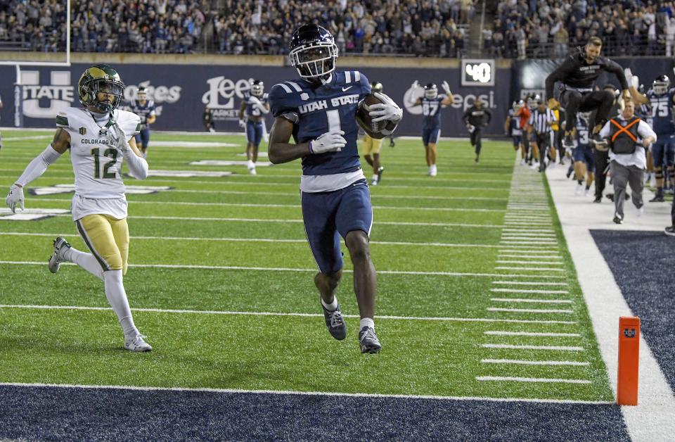 Utah State wide receiver Jalen Royals (1) runs into the end zone for a touchdown as Colorado State defensive back Dominic Morris (12) trails during the second half of an NCAA college football game Saturday, Oct. 7, 2023, in Logan, Utah. | Eli Lucero/The Herald Journal via AP