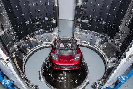 A red Tesla Roadster is seen during preparations to use it as a mock payload for the launch of a SpaceX Falcon Heavy rocket, in Cape Canaveral, Florida, U.S. December 6, 2017. Flickr.com/photos/SpaceX via REUTERS.