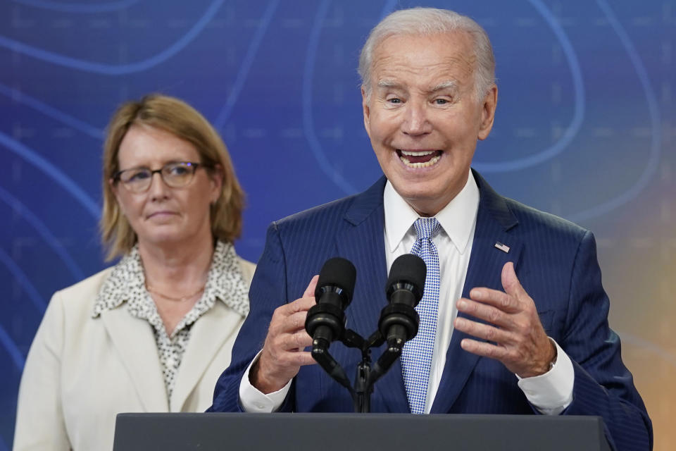 President Joe Biden speaks during an event to announce new measures aimed at helping communities deal with extreme weather, in the South Court Auditorium on the White House Campus, Thursday, July 27, 2023, in Washington. Federal Emergency Management Agency administrator Deanne Criswell listens at left. (AP Photo/Evan Vucci)