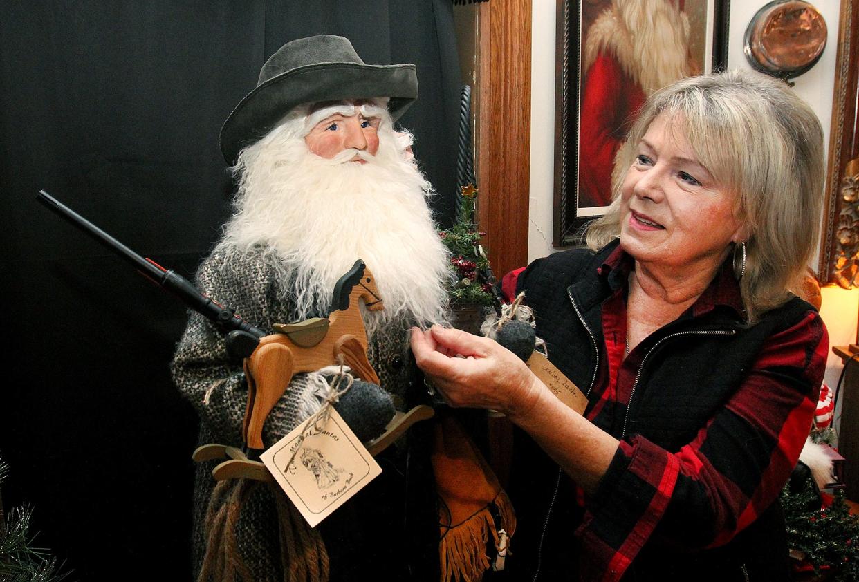 Barbara Buck adjusts the beard on the "Gentleman Santa" on Tuesday, Nov. 30, 2021, in her studio in Freeport.