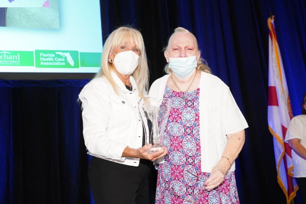 Kathy Gallin, Florida Health Care Association senior vice president, left, presents FHCA’s 2022 Resident of the Year Award to Betty Souder.