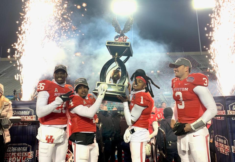 The Houston Cougars celebrate winning the 2022 Radiance Technologies Independence Bowl over Louisiana-Lafayette in the 46th version of the postseason contest.