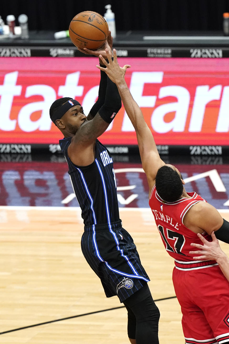 Orlando Magic guard Terrence Ross, left, shoots over Chicago Bulls forward Garrett Temple during the first half of an NBA basketball game in Chicago, Wednesday, April 14, 2021. (AP Photo/Nam Y. Huh)