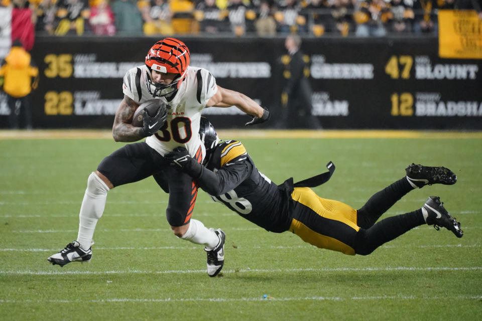 Cincinnati Bengals running back Chase Brown (30) is tackled by Pittsburgh Steelers safety Miles Killebrew (28) during the second half of an NFL football game Saturday, Dec. 23, 2023, in Pittsburgh. (AP Photo/Gene J. Puskar)